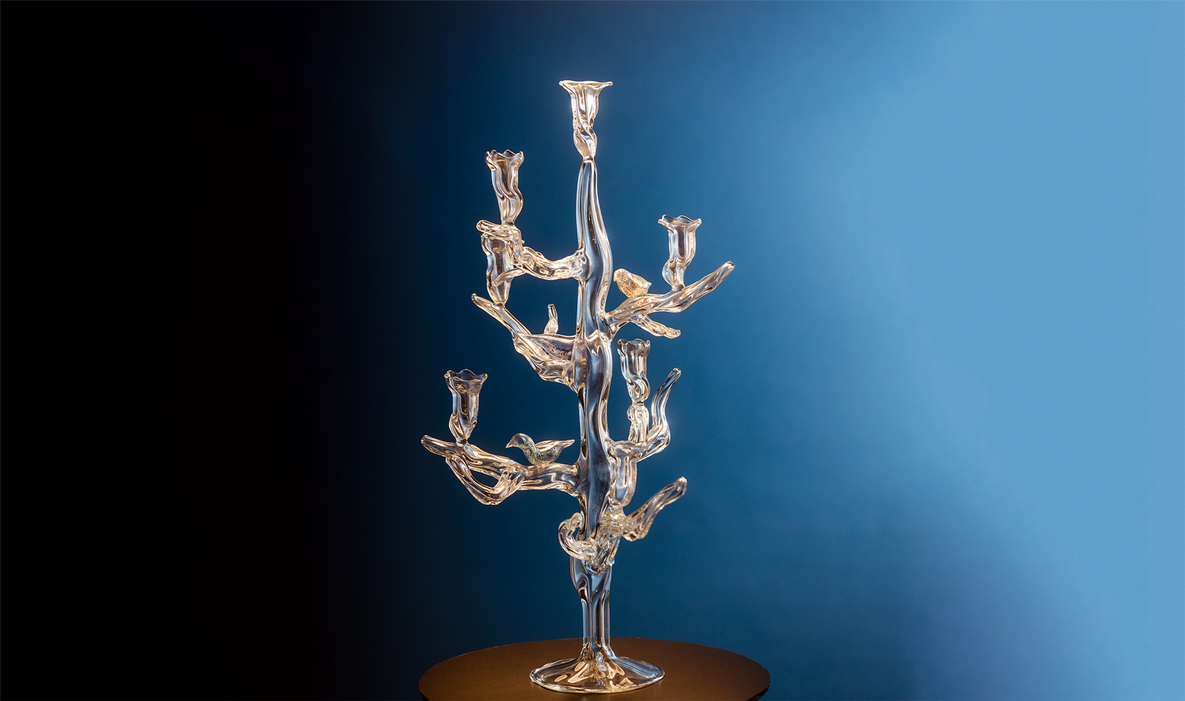 Tree of Life 7 Candles Candelabra – hand-blown optic borosilicate glass with organic tree-like arms and sculptural base, crafted in Bucharest by Gabriela Seres.