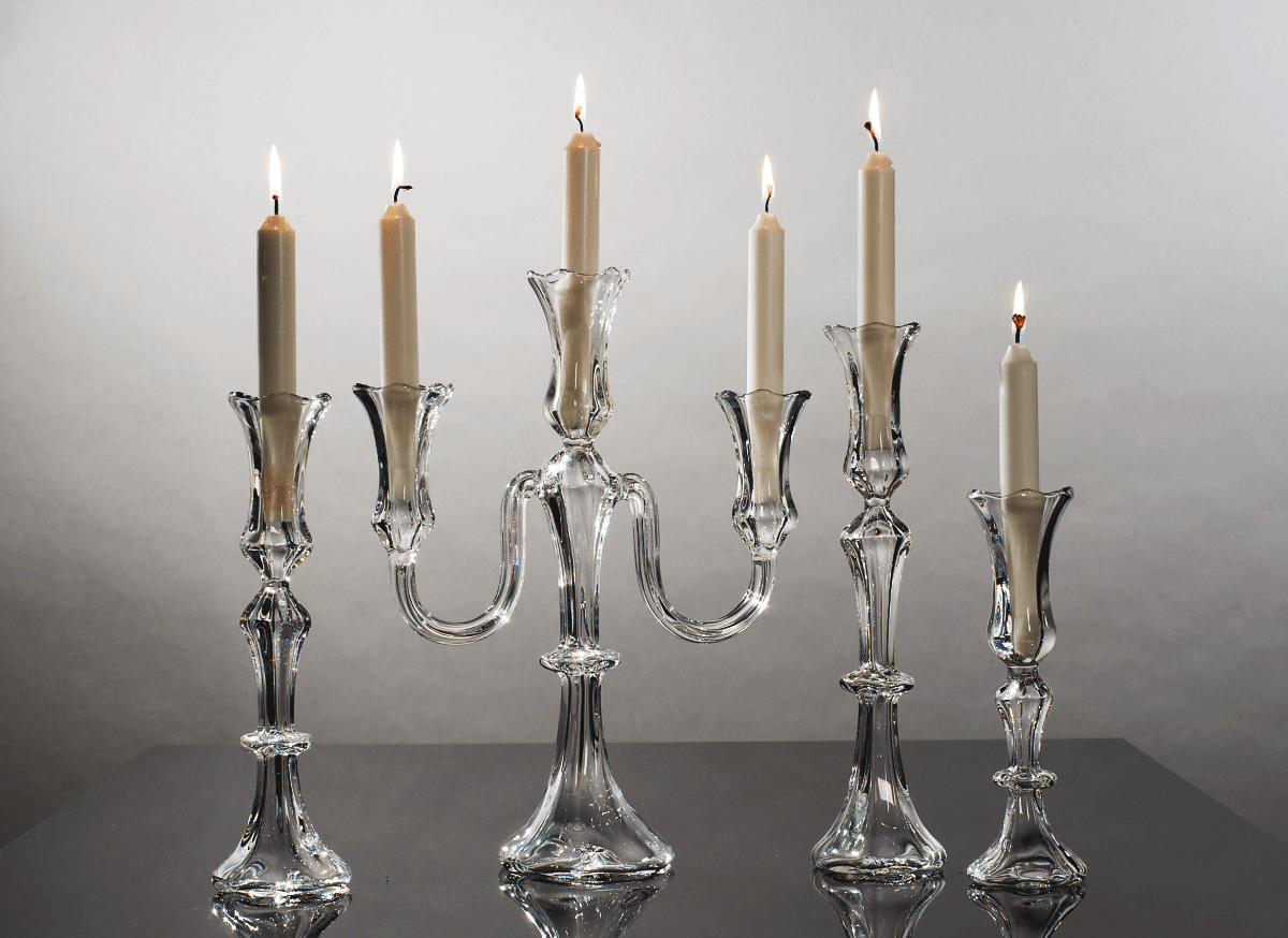 Small candleholders and candelabra with lit candles