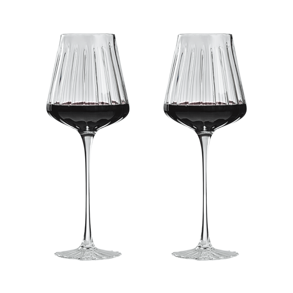 Two wine glasses filled with red wine on a white background