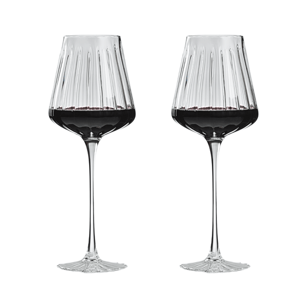 Two wine glasses filled with red wine on a white background