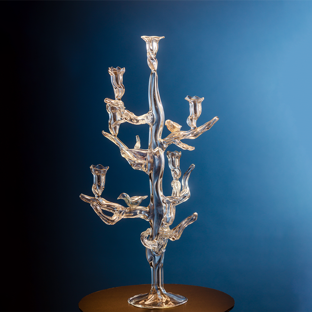 Glass candelabra against a blue gradient background