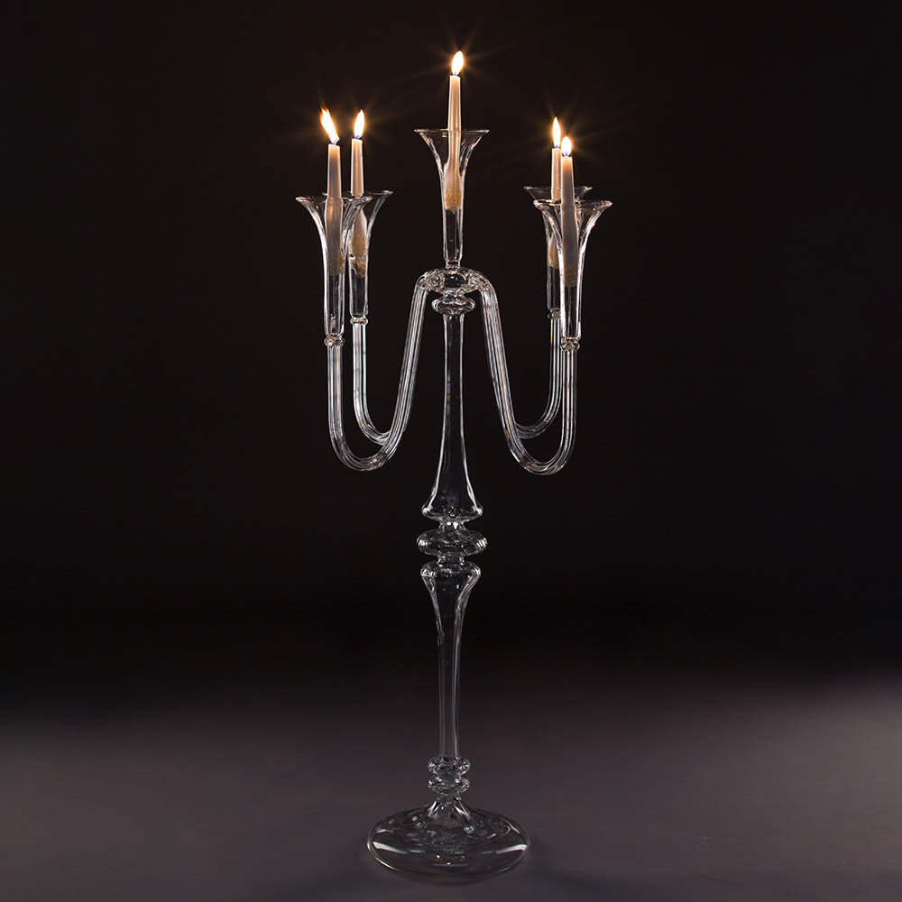 Glass Candelabra with 5 lit candles on a black background. Handmade glass candelabra in the Gabriela Seres Atelier