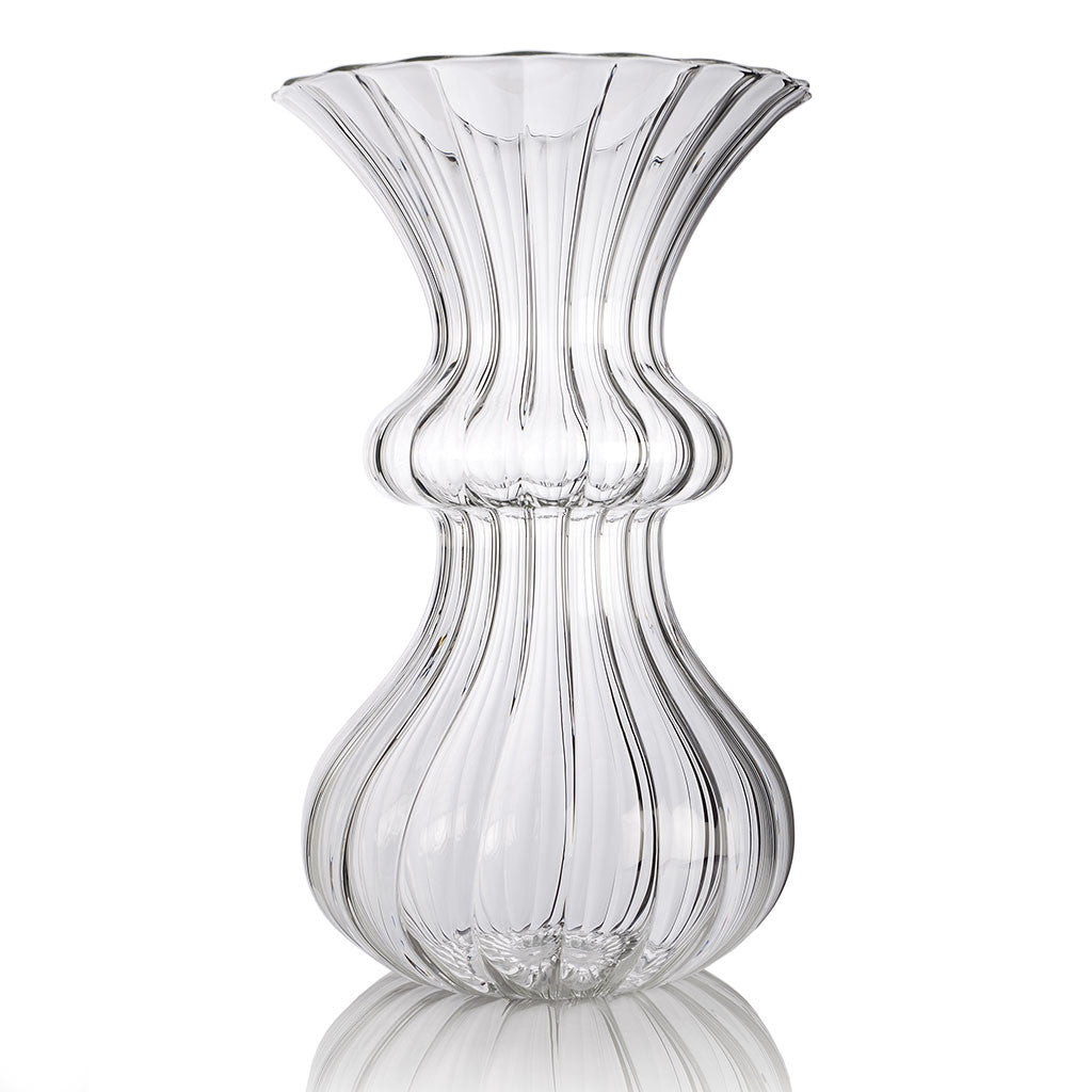 A clear glass vase with a tulip-shaped design, handmade.