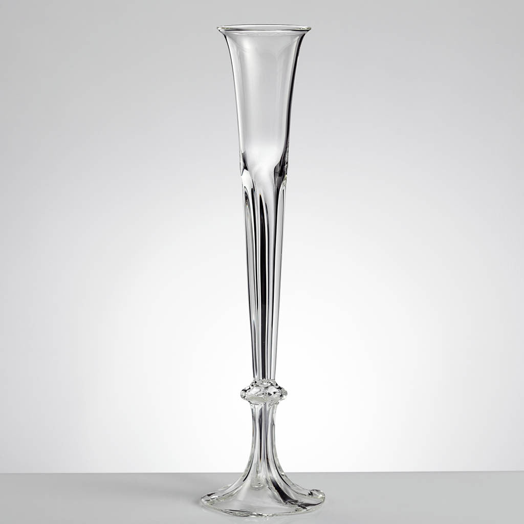 A clear, tall, Art Deco-inspired glass vase with a narrow neck and a round base.